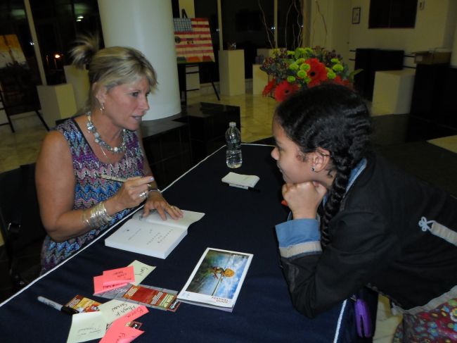 Alison signing Layla's book