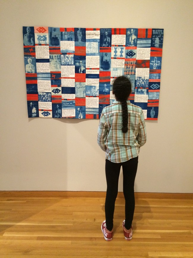 Layla reading the quilt