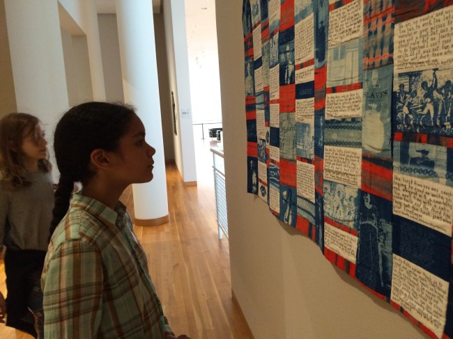 Layla reading the quilt