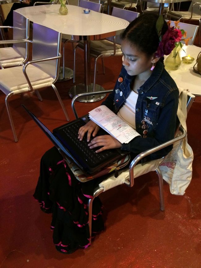 Layla getting homework done before the performance
